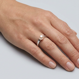 Bague en argent 925 avec perle de culture rose portée à l'index.