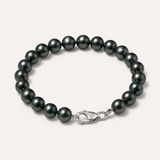 Bracelet en argent 925 orné de perles noires rondes avec fermoir mousqueton argenté.