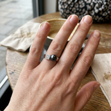 Bague en argent 925 avec perle noire de Tahiti et pavé, portée à la main.