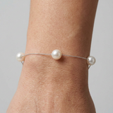 Bracelet 3 perles de culture blanches 7-8 mm sur chaîne argent 925, porté au poignet.