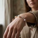 Bracelet argent 925 et perles de culture multicolores porté au poignet.