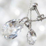 Parure argent 925 avec pendentif et boucle d'oreille en cristal taillé transparent.